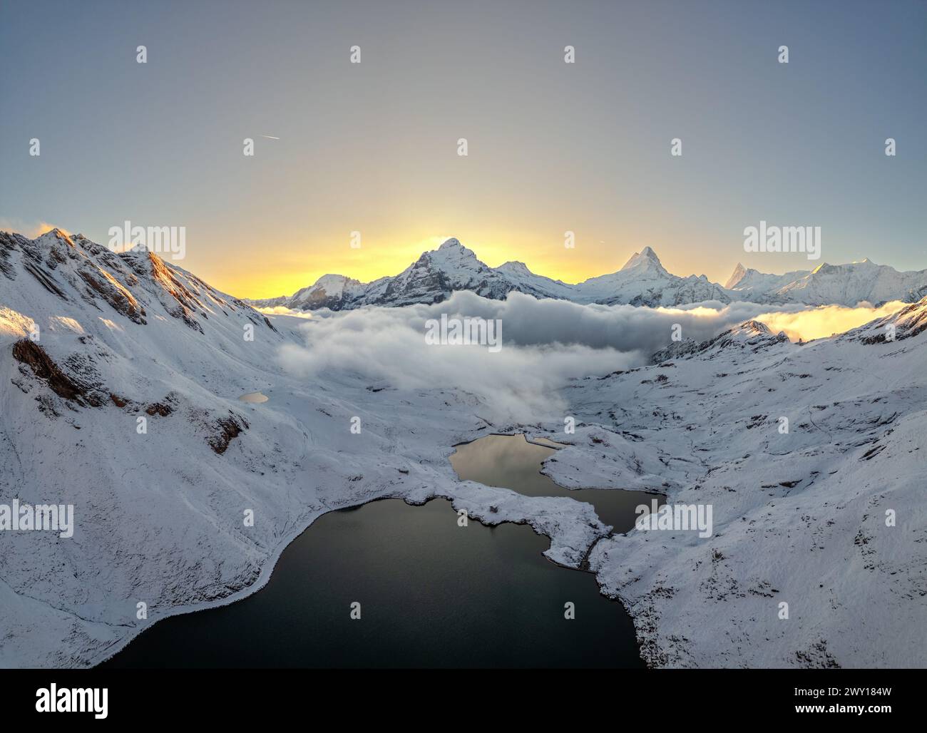Lake Bachalpsee with Jungfrau, Eiger, and Monch Peaks after an early snow. Stock Photo