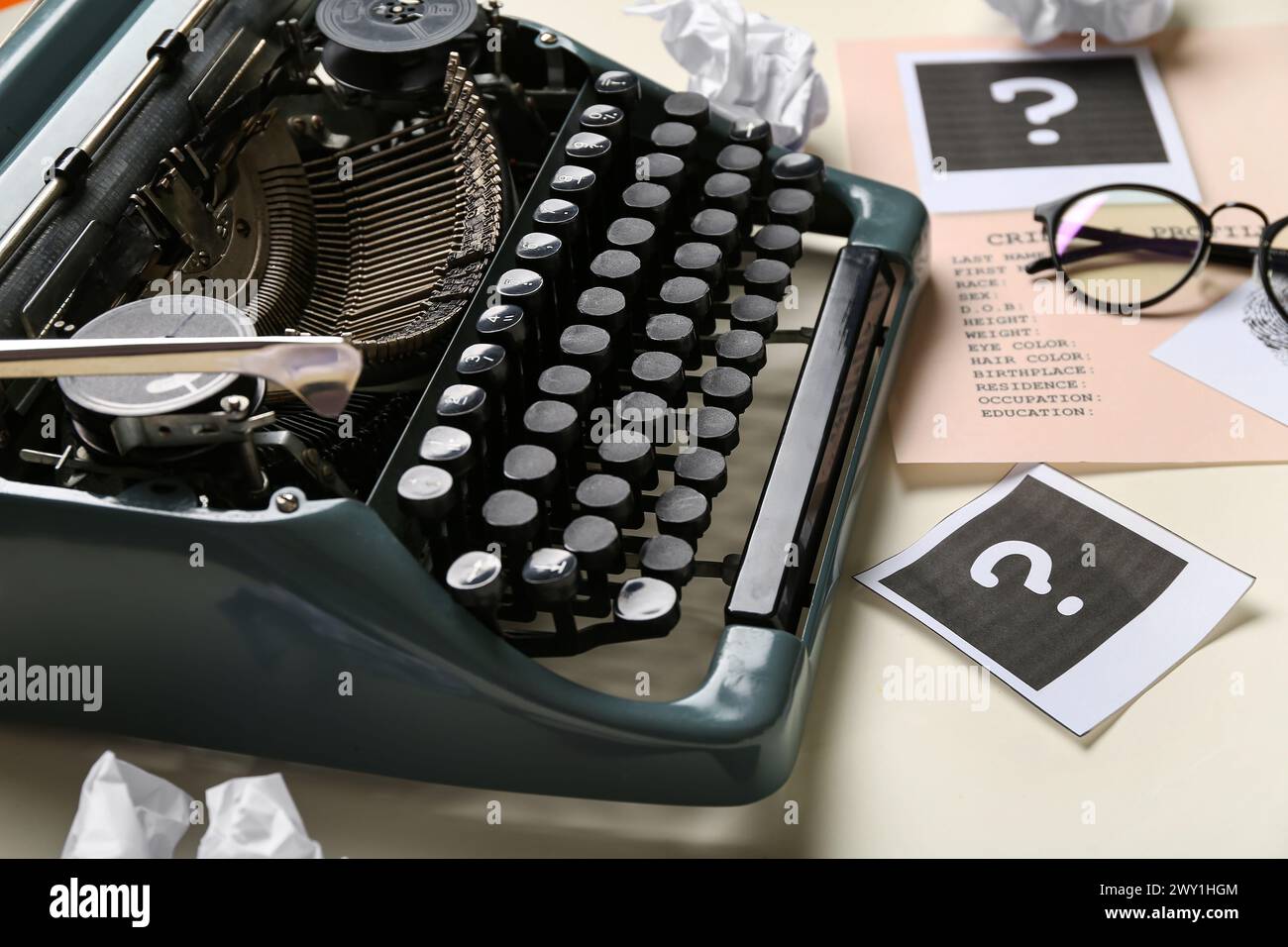 Retro typewriter, question marks and criminal files on light background