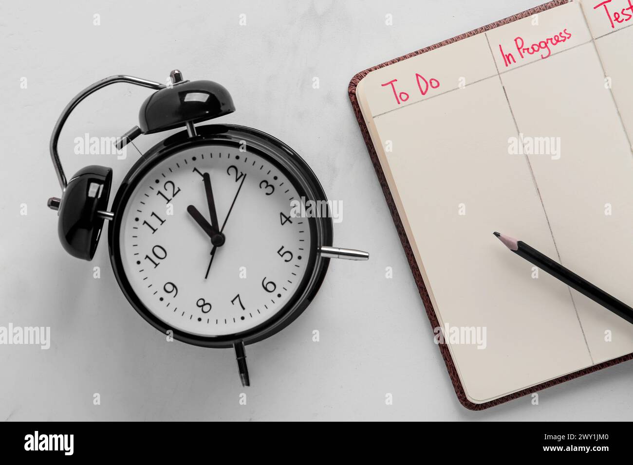 Time Taskfor Notebook Open notebook with to-do list and alarm clock on white background. Time ...