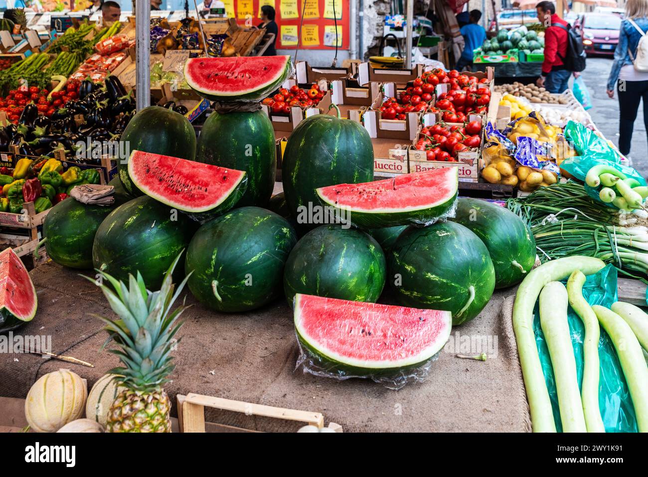 Palermo, Italy - May 13, 2023: Watermelons in a fruit and vegetable shop in Ballaro Market, street food market with people around in Palermo, Sicily, Stock Photo