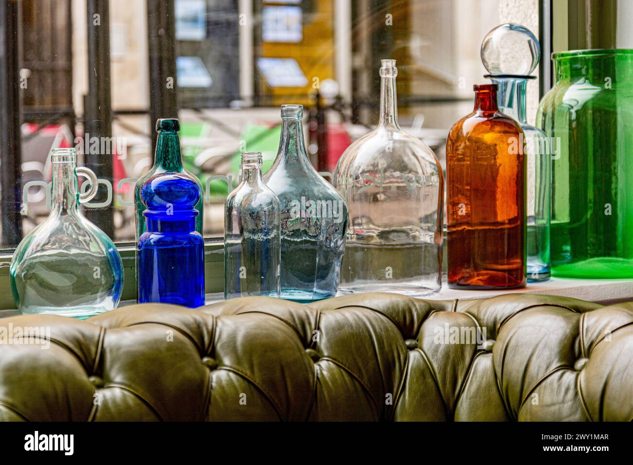 Multicolor vintage bottles on a windowsill Stock Photo