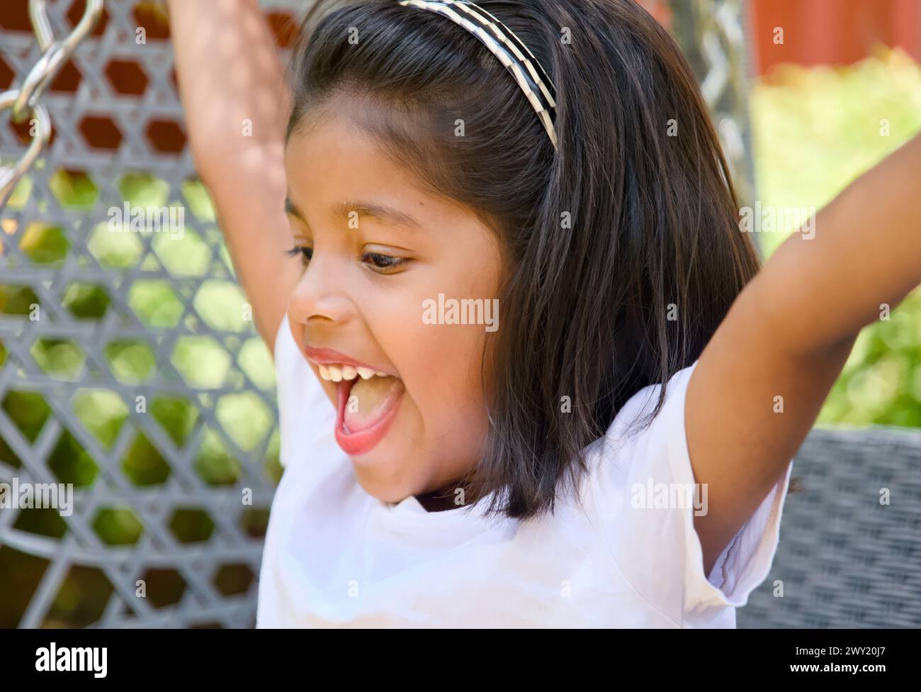 Portrait of a young asian girl playing on the playground swing Stock ...