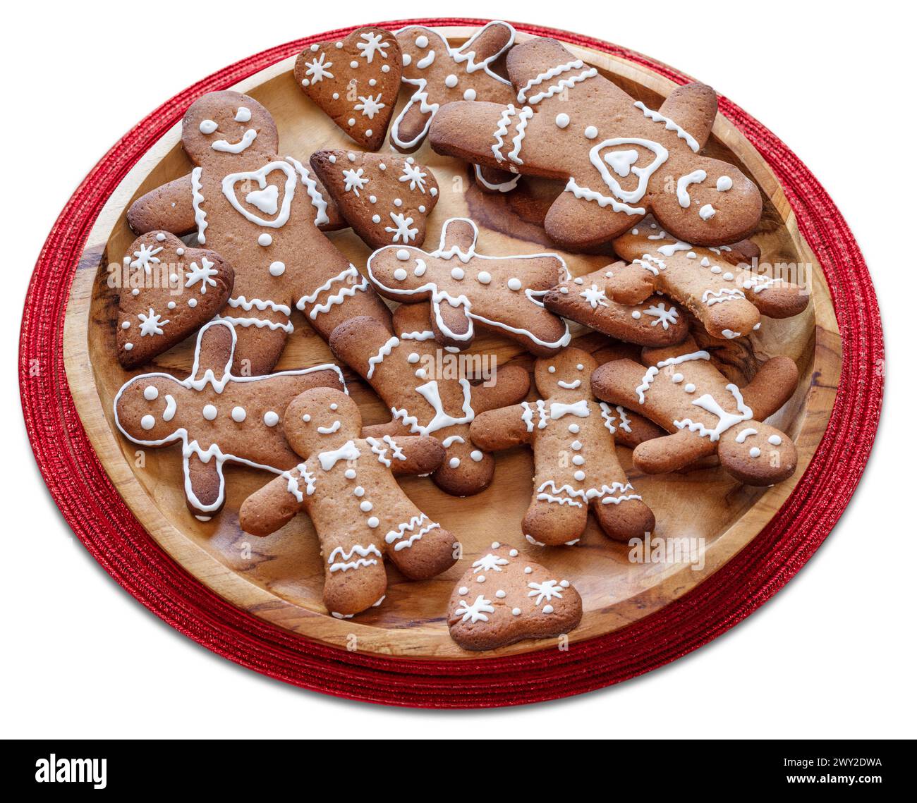 Wooden plate with gingerbread men on white background. File contains clipping path. Stock Photo