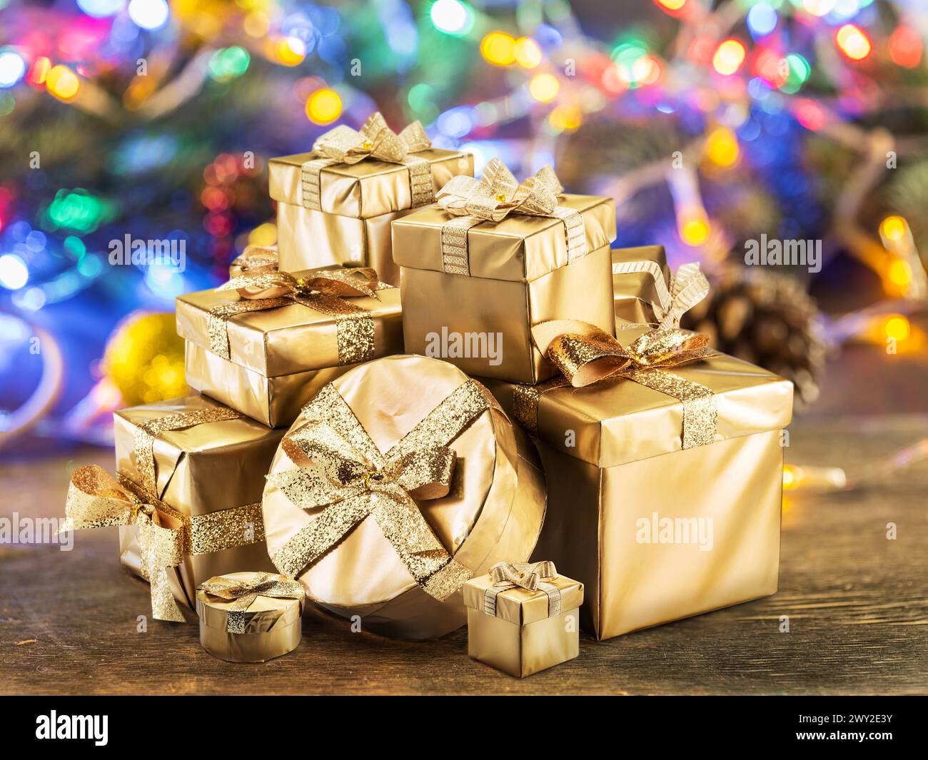 Christmas gifts as the symbol of Christmas happiness and miracle. Sparkling fairy lights at the background. Stock Photo