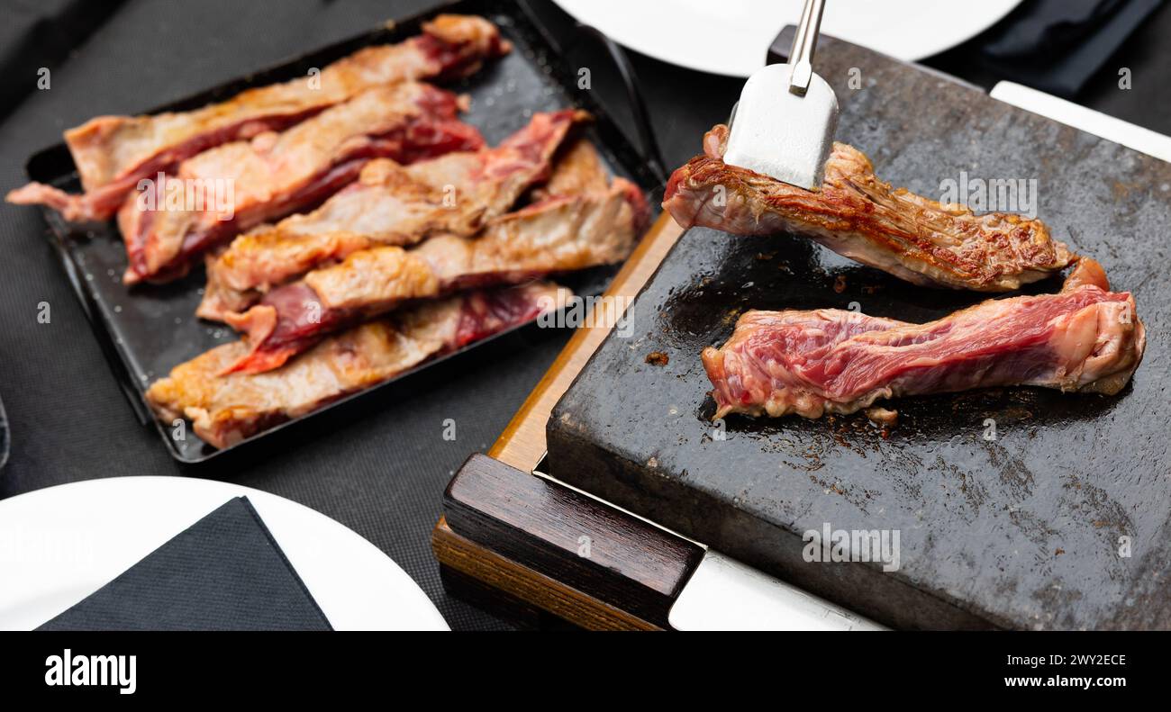 Hot stone cooking of beef meat Stock Photo - Alamy