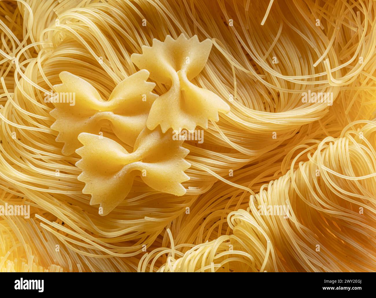 Italian pasta vermicelli and farfalle close-up. Food background. Stock Photo
