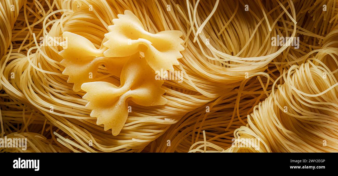 Italian pasta vermicelli and farfalle close-up. Food background. Stock Photo