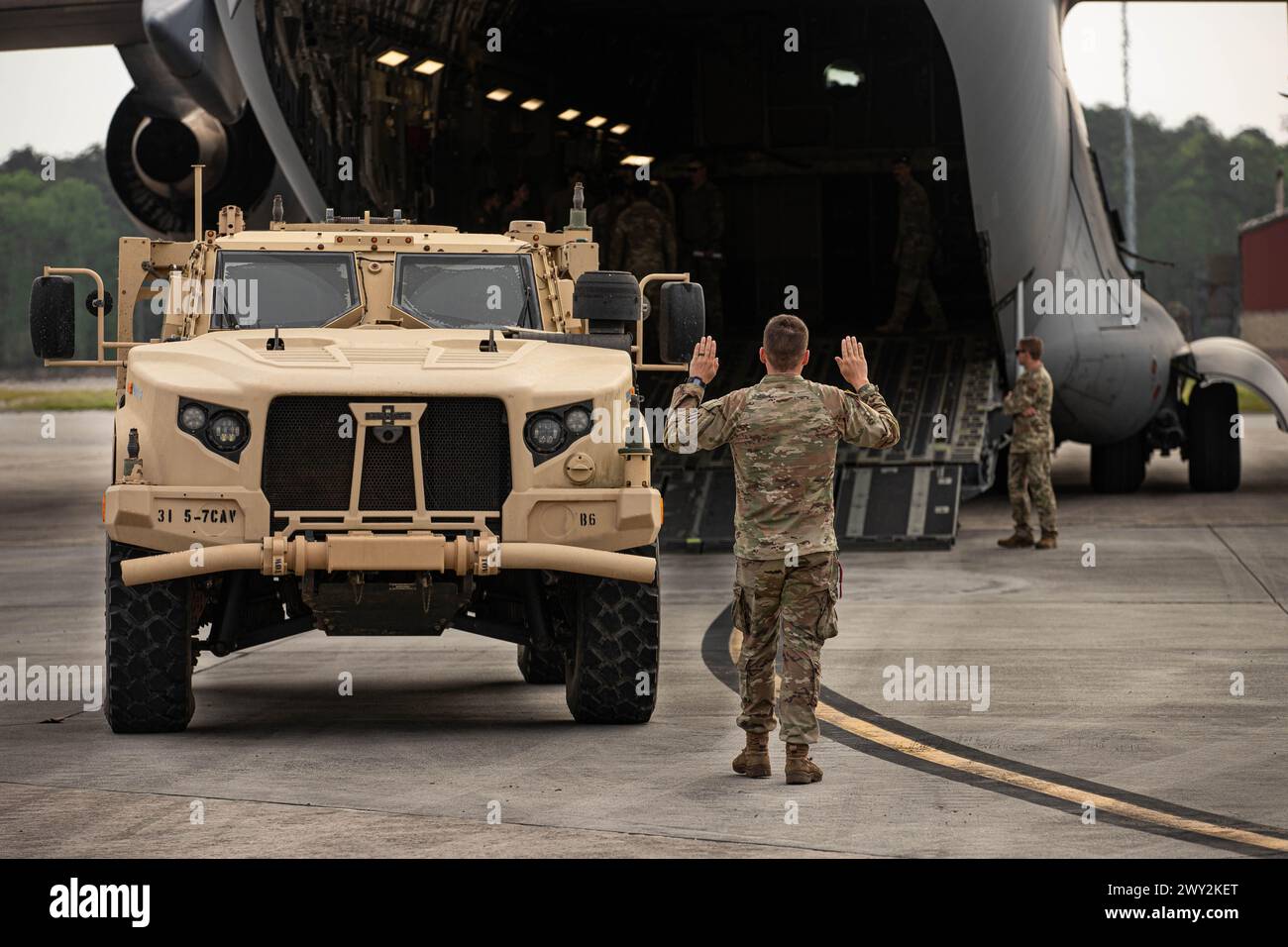 Soldiers with the 5th Squadron, 7th Cavalry Regiment, 1st Armored Brigade Combat Team (5-7 CAV), 3rd Infantry Division (3ID) load an armored vehicle into C-17 and C-5 aircraft at Hunter Army Airfield, Savannah, Georgia, Apr. 2, 2024. Swamp Avenger, a readiness exercise, prepares 3ID Soldiers to respond to any possible threats worldwide. (U.S. Army photo by Pfc. Tiana Brown) Stock Photo