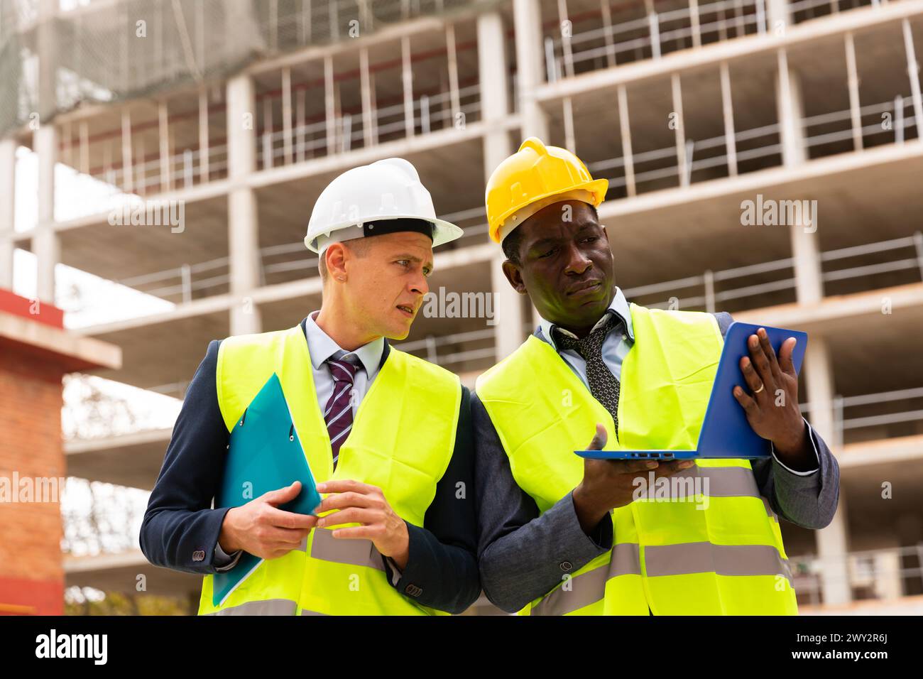 Two architects discussing construction project Stock Photo - Alamy