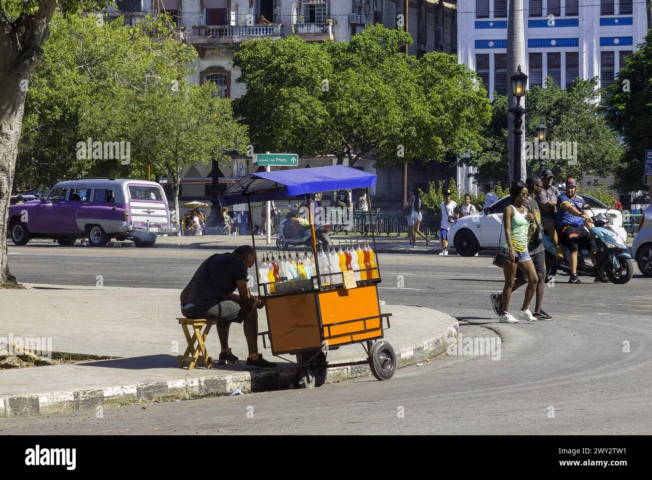 Cuban man selling flavored ice in a cart on a city street, Havana, Cuba Stock Photo
