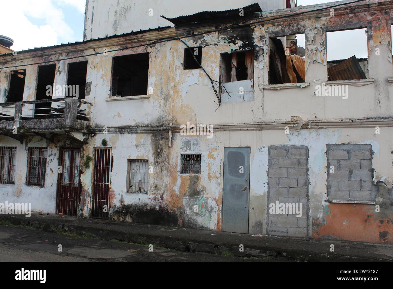 Abandoned and burned two-story building in Fort-de-France, Martinique with danger spraypainted on it Stock Photo
