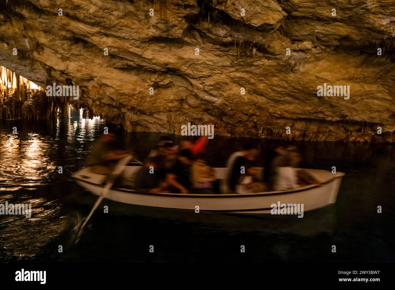 People in the boat on lake in amazing Drach Caves in Mallorca, Spain Stock Photo