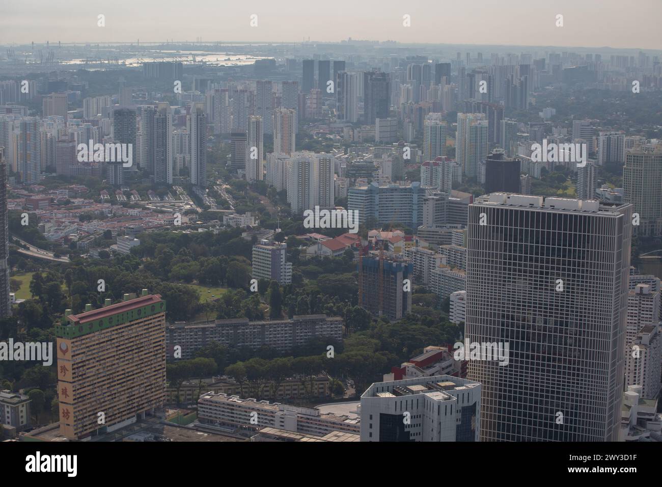 Aerial perspective view of Singapore downtown skyline with plenty of buildings on the island. Landscape photography from high view. Stock Photo