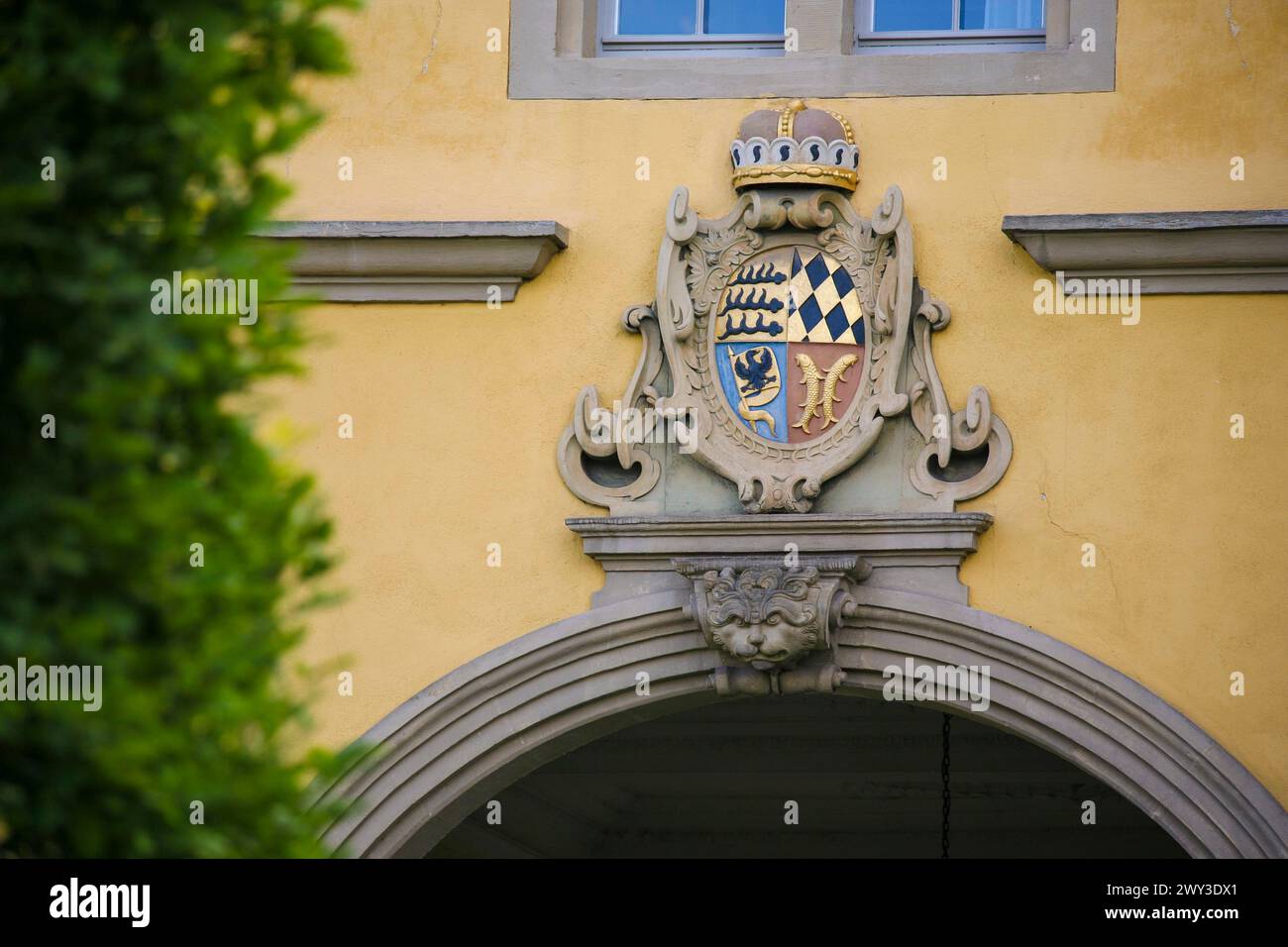 Mythical creature and ducal Wuerttemberg coat of arms above archway, stone figure, face, Winnental Castle built in the 15th century by the Teutonic Stock Photo