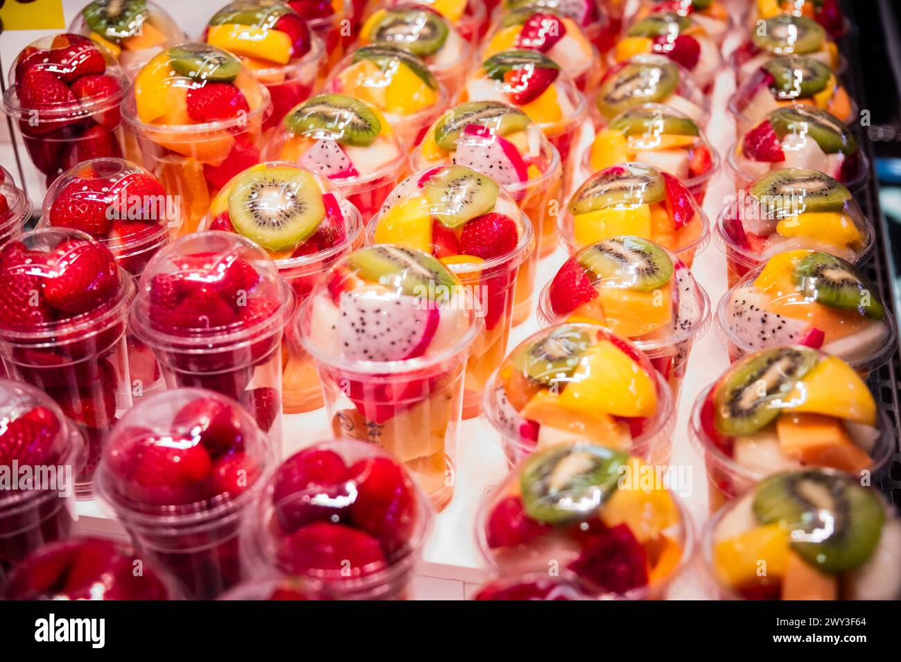 Fruit salad in plastic packaging at a market in Barcelona Stock Photo
