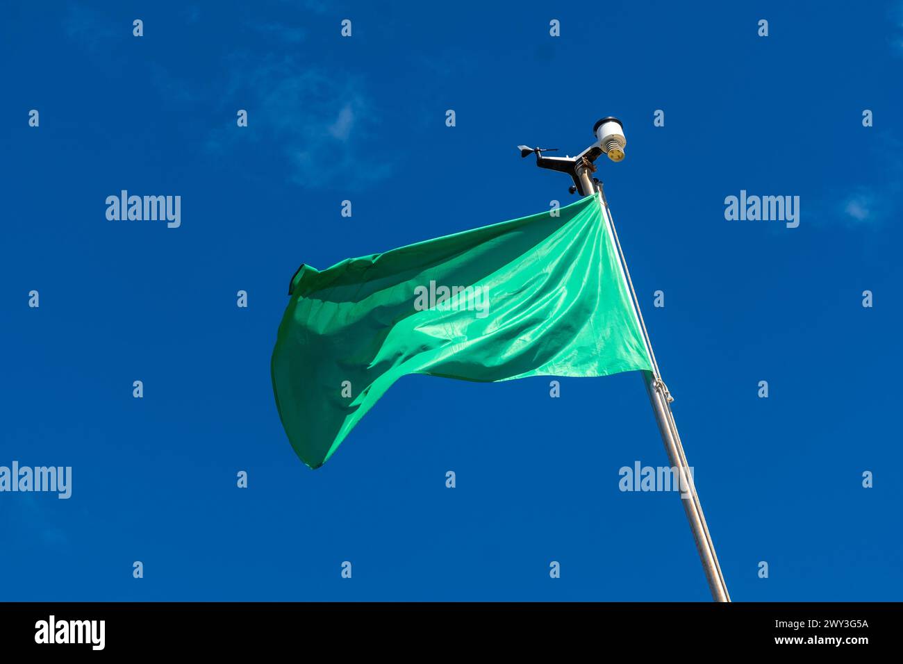 Green flag on the beach in summer summer, lifeguards sign that you can