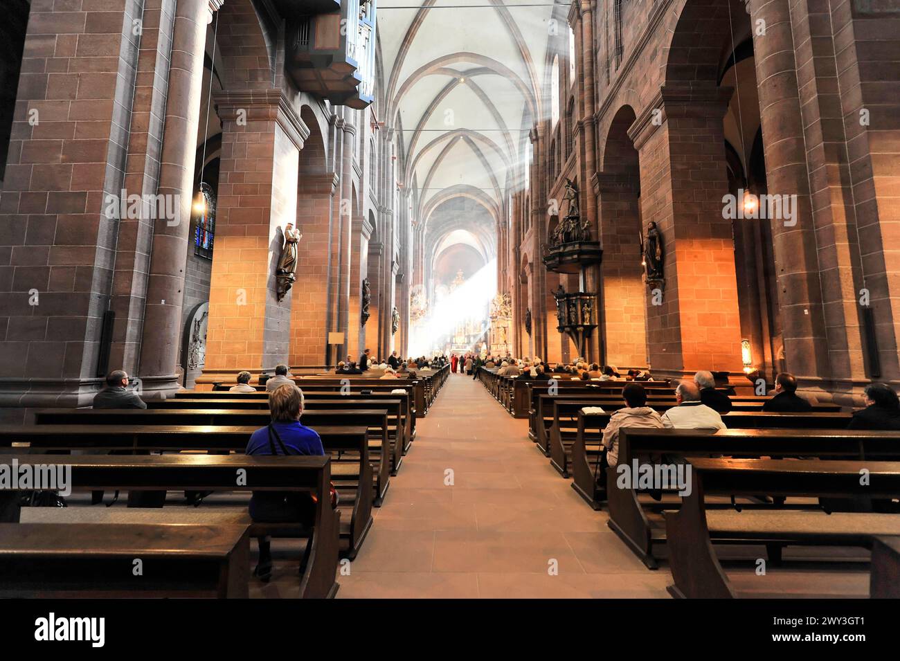 Speyer Cathedral, rays of light fall on visitors in the interior of Worms Cathedral, Speyer Cathedral, Unesco World Heritage Site, foundation stone Stock Photo
