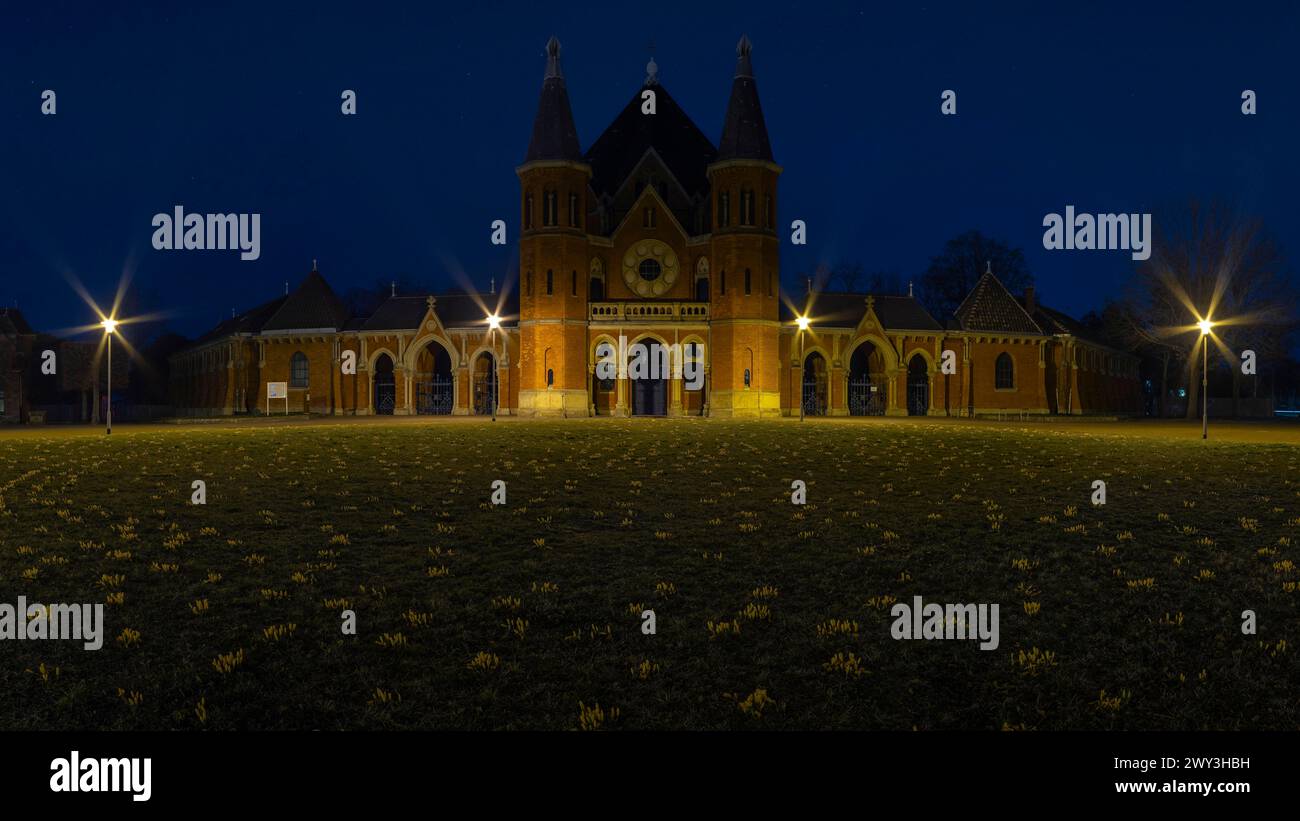 Main entrance of the cemetery in Hanover Stoecken with a lawn with crocuses in the foreground, dutch yellow crocus (Crocus flavus), Historical Stock Photo