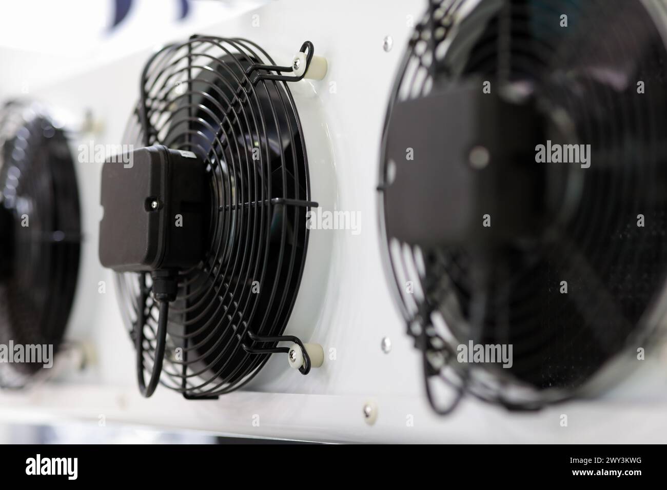 Electric fans of industrial fluid cooler close up. HVAC system. Selective focus. Stock Photo