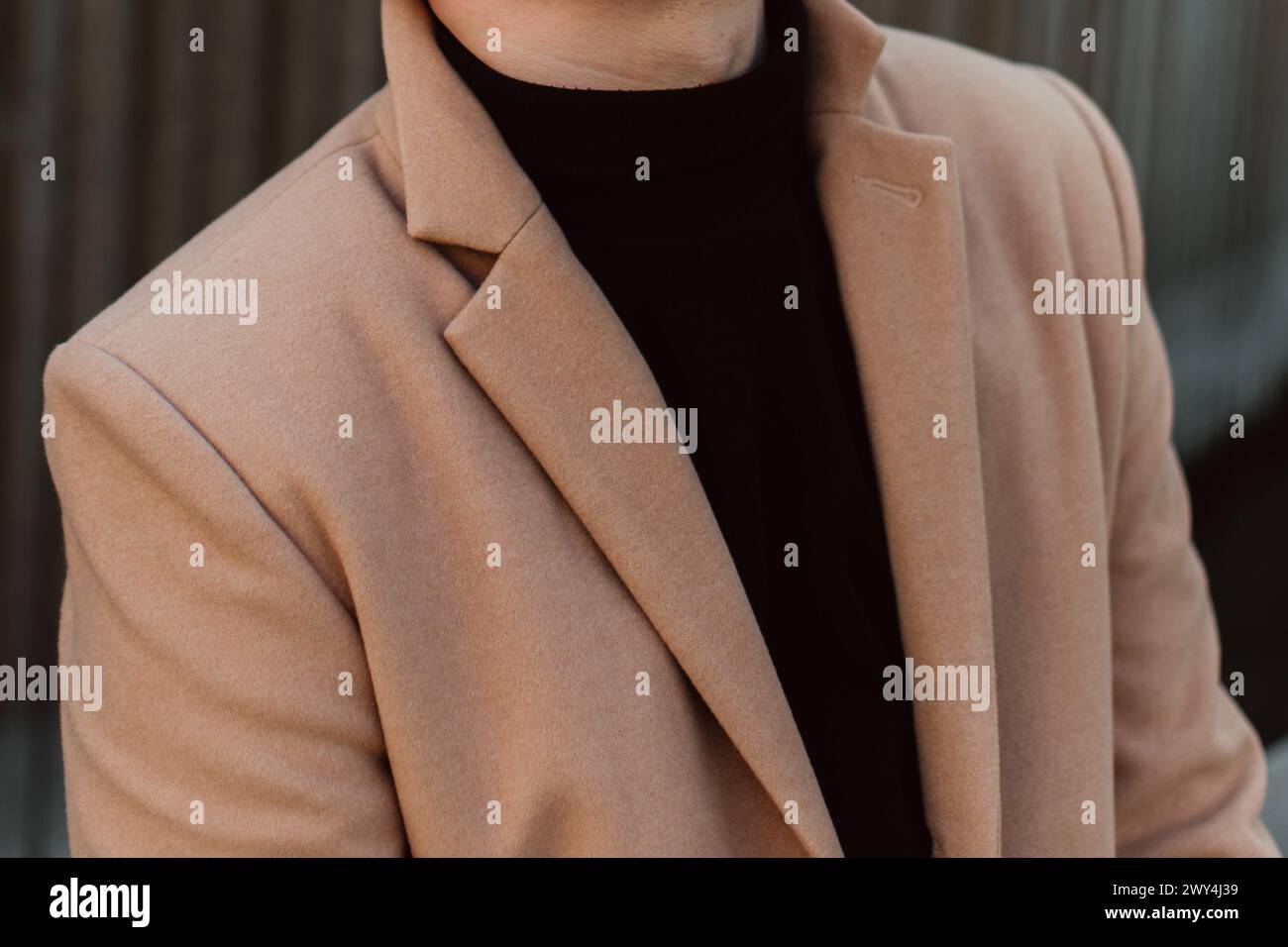 Details of beige brown men's coat and black turtleneck. Classic street outerwear Stock Photo