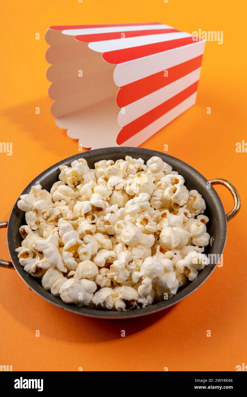 A box in the background behind a bowl of popcorn. Stock Photo