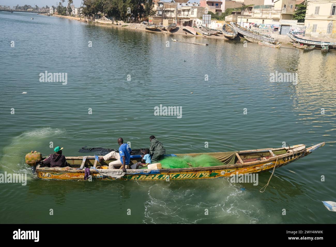 Nicolas Remene / Le Pictorium -  The Guet Ndar district in Saint-Louis, Senegal -  31/03/2024  -  Senegal / Saint-Louis / Saint-Louis  -  Fishing boats, one of the main economic activities in Saint-Louis, Senegal, on March 31, 2024.                                                                 Quet Ndar is a fishing district in Saint-Louis, Senegal, also known for having one of the highest population densities in the world. It is located on the Langue de Barbarie, which has been facing coastal erosion for years. Today, the district is threatened by the heavy swell that has battered its shore Stock Photo