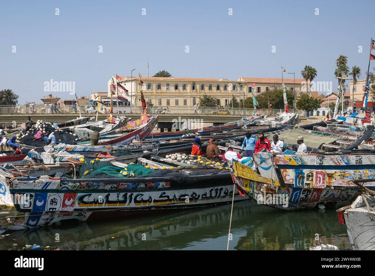 Nicolas Remene / Le Pictorium -  The Guet Ndar district in Saint-Louis, Senegal -  31/03/2024  -  Senegal / Saint-Louis / Saint-Louis  -  Fishing boats, one of the main economic activities in Saint-Louis, Senegal, on March 31, 2024.                                                                 Quet Ndar is a fishing district in Saint-Louis, Senegal, also known for having one of the highest population densities in the world. It is located on the Langue de Barbarie, which has been facing coastal erosion for years. Today, the district is threatened by the heavy swell that has battered its shore Stock Photo