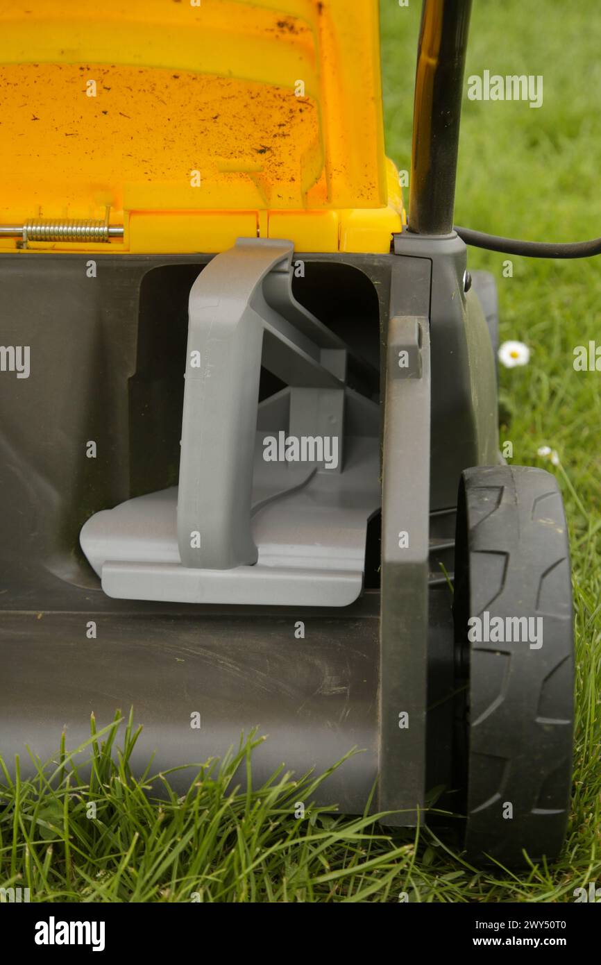 Close up image of lawn mower with inserted mulching plug, a cutting