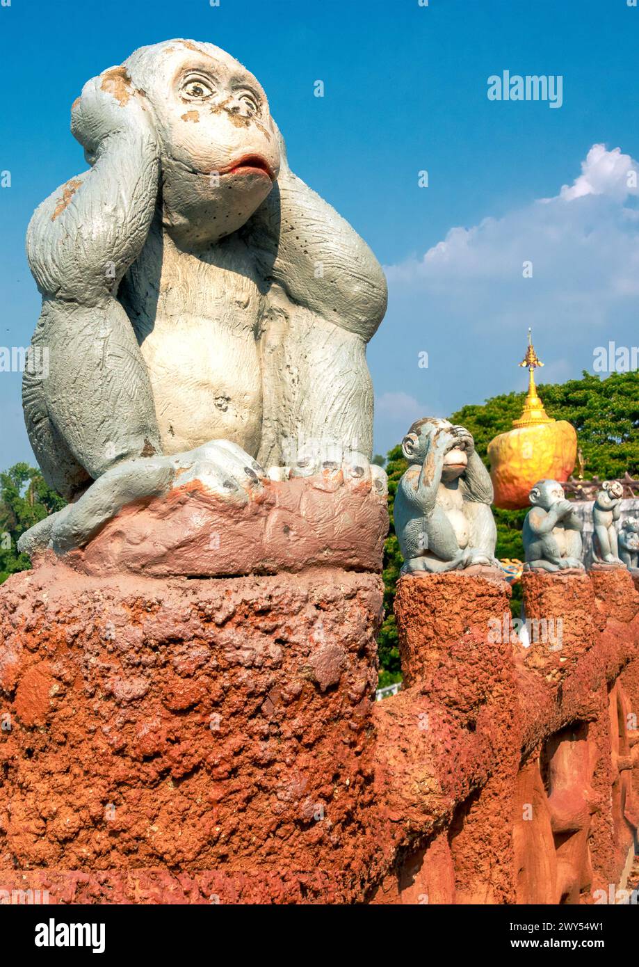 Sculptures of three monkeys sitting on orange columns with ‘see no evil, hear no evil, speak no evil’ theme. Stock Photo