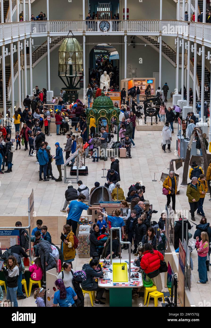 Crowded grand gallery during the Easter holidays and Science Festival activities for children, National Museum of Scotland, Edinburgh, UK Stock Photo