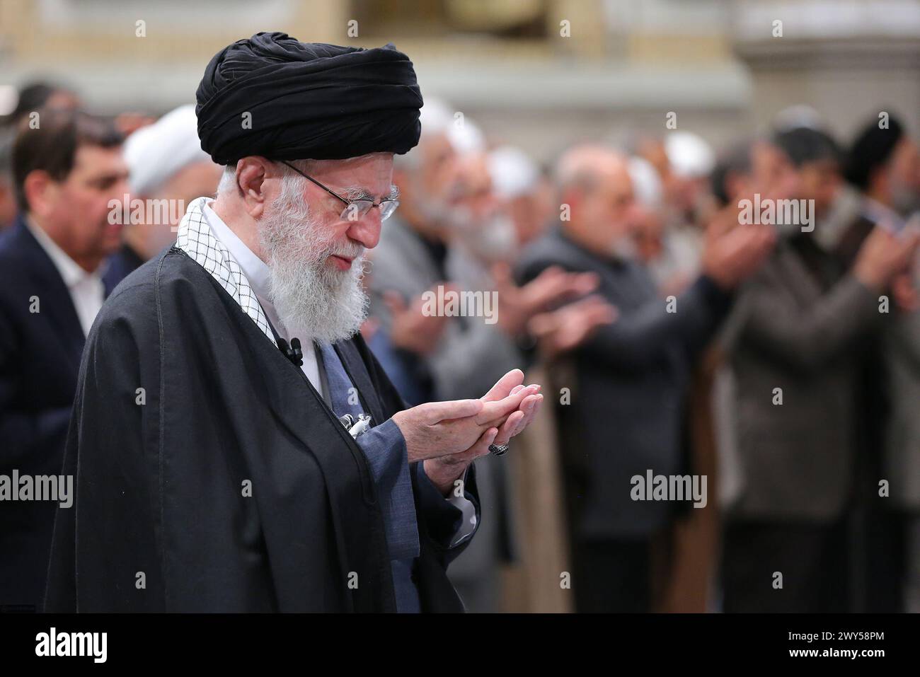 April 3, 2024, Tehran, Iran: Iranian Supreme Leader Ayatollah ALI KHAMENEI says prayers after a meeting with politicians, the Iranian government, and military officials in Tehran. Khamenei said that 'Israel will be slapped' following the strike against the Iranian consulate in Syria. at least seven IRGC military advisors, including generals Mohammad Reza Zahedi and Mohammad Hadi Haj Rahimi, were killed in an airstrike on the Iranian consulate building in Syria's capital Damascus on 01 April. Iran has blamed Israel for the attack and vowed to respond. (Credit Image: © Iranian Supreme Leader'S O Stock Photo