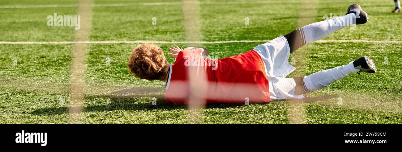 A person in casual clothing lying on the ground, looking relaxed, next to a soccer ball. The sun is shining brightly, casting shadows on the ground. T Stock Photo