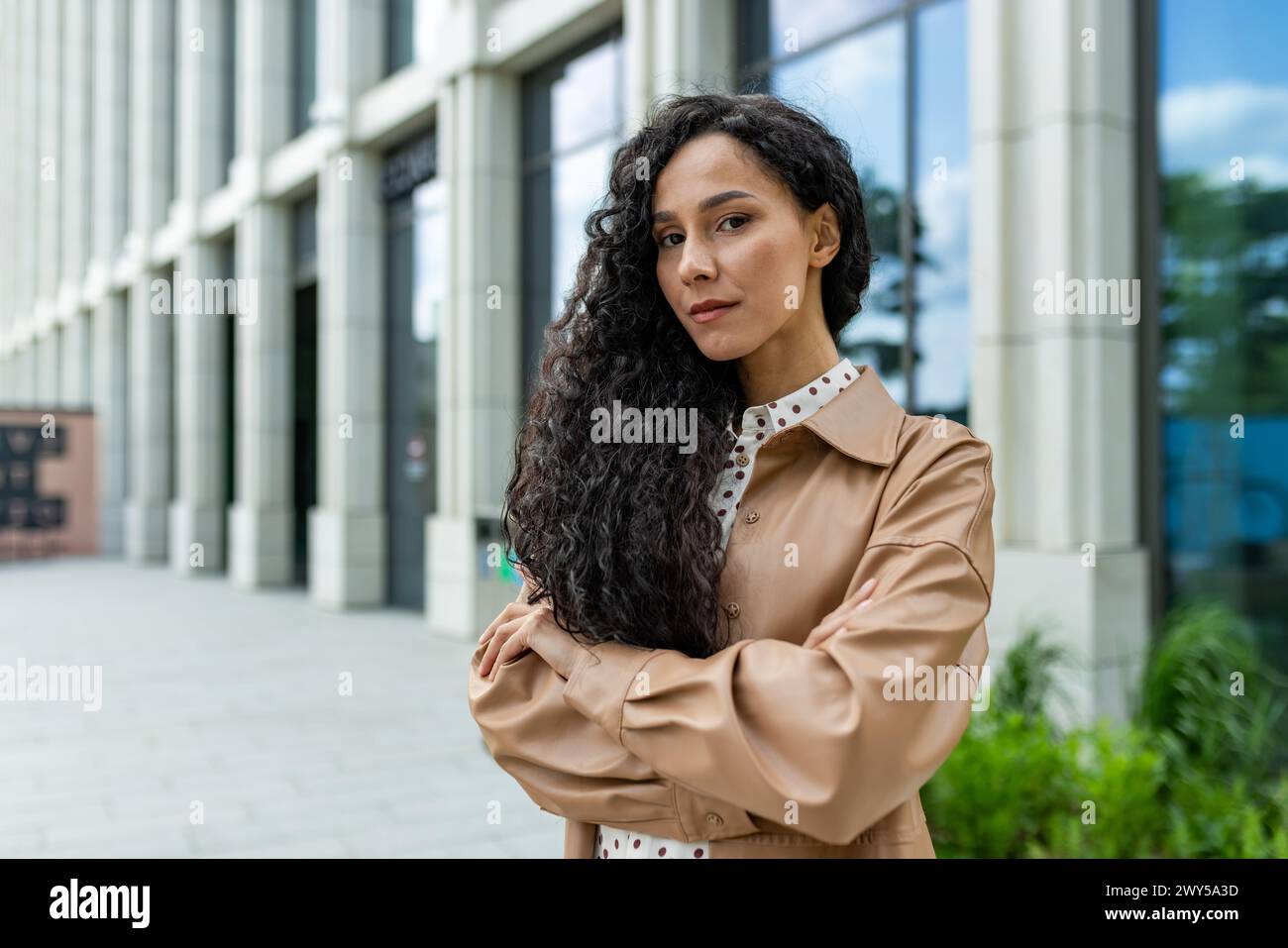 Curated visual reference: Gallery Detail: A Young Professional Woman Stands Confidently Outside A Modern Office