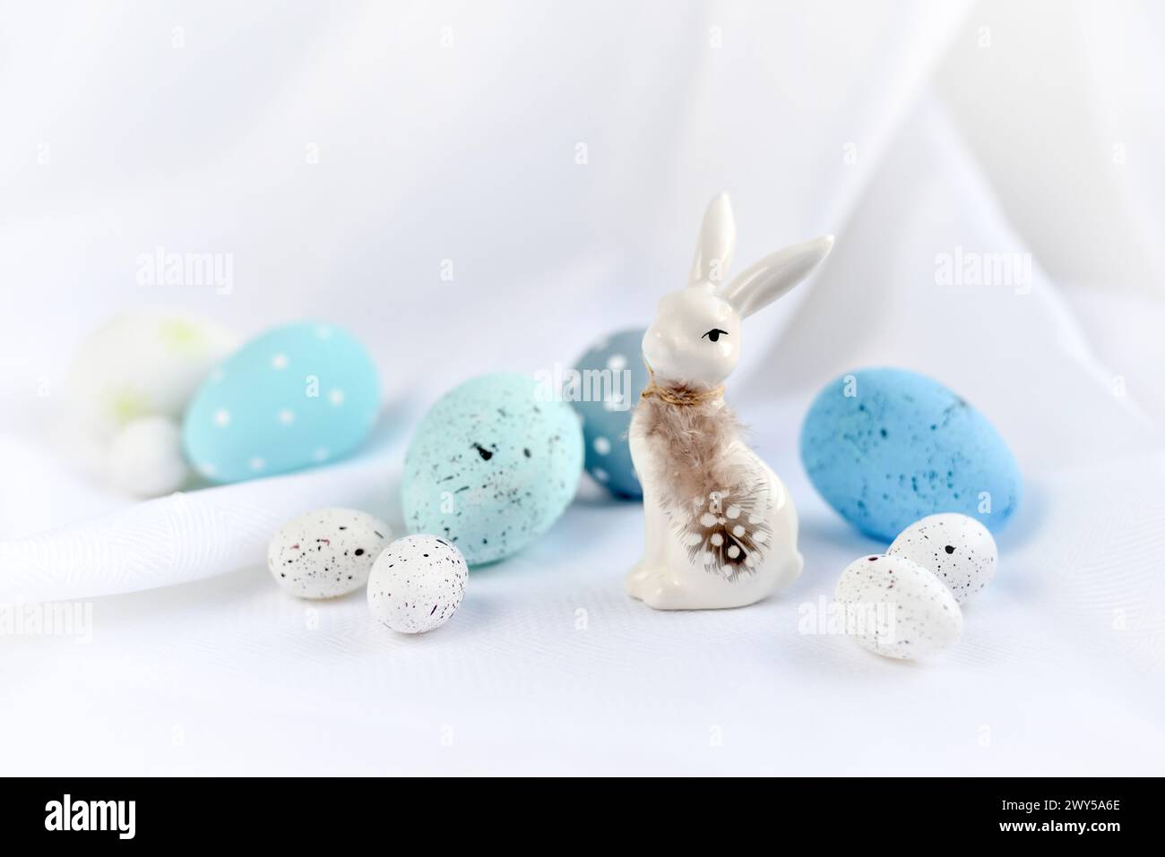 Easter composition with white rabbit and eggs on a white background. The minimal concept. Stock Photo