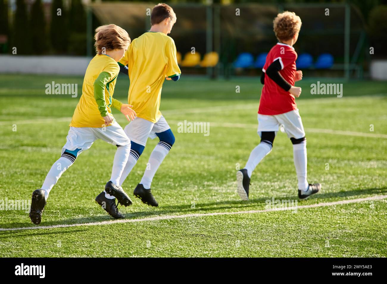 A dynamic scene unfolds as a group of young men engage in a spirited game of soccer, showcasing their agility, teamwork, and competitive spirit on the Stock Photo
