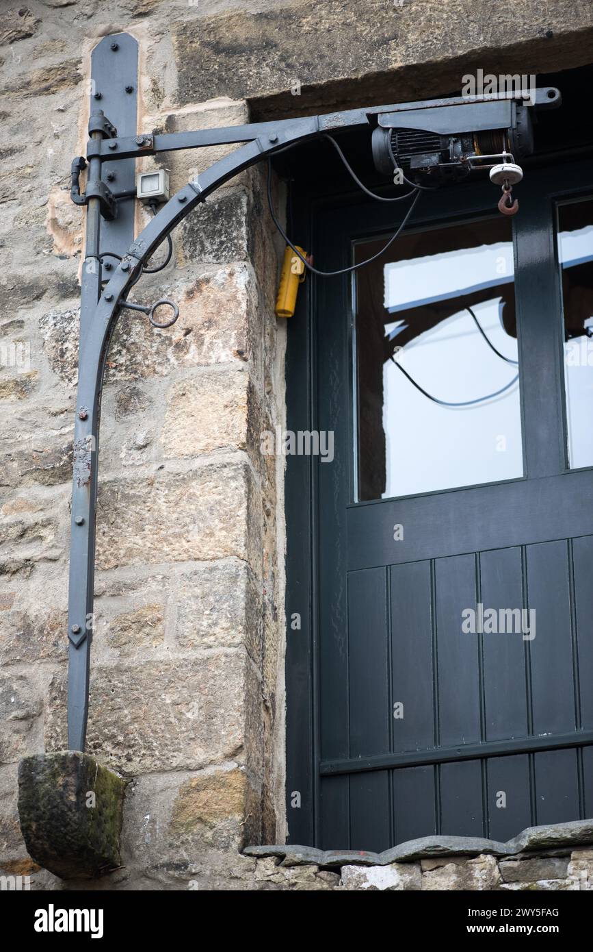 Pulley system hoist, or remnants of in some cases, are quirky features of some Settle (North Yorkshire) properties enabling lifting to the upper floor Stock Photo
