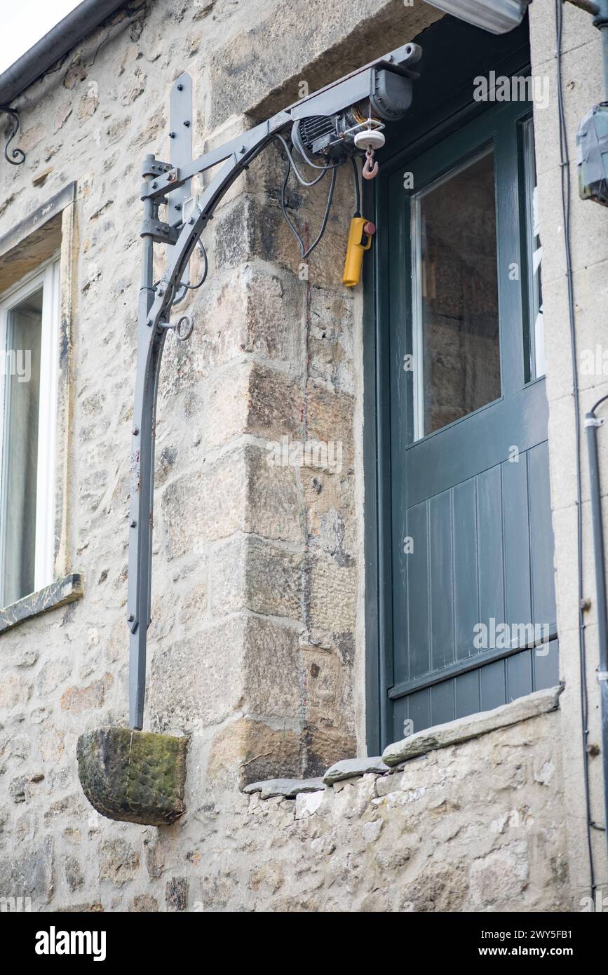 Pulley system hoist, or remnants of in some cases, are quirky features of some Settle (North Yorkshire) properties enabling lifting to the upper floor Stock Photo