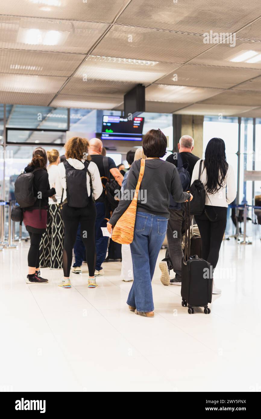 Please Wait In Line People waiting in queue at airport security Stock Photo - Alamy