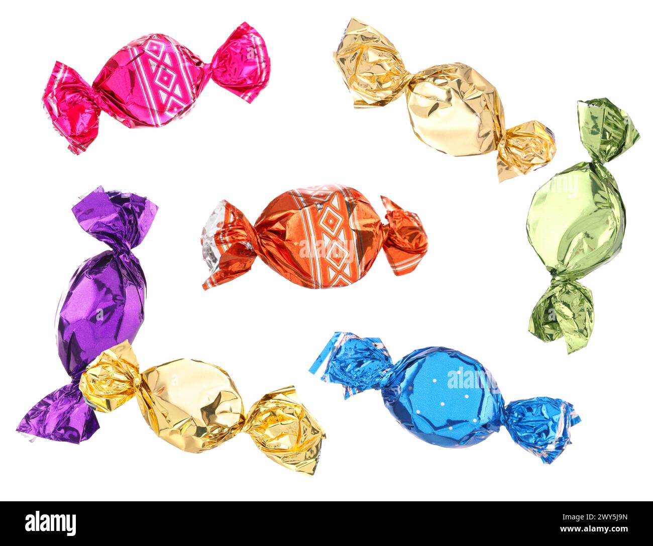 Candies in bright wrappers falling on white background Stock Photo