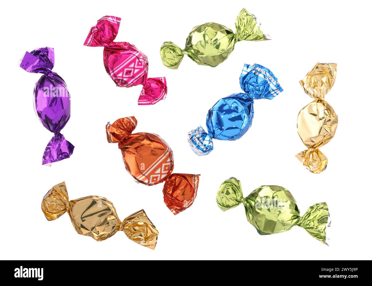 Candies in bright wrappers falling on white background Stock Photo