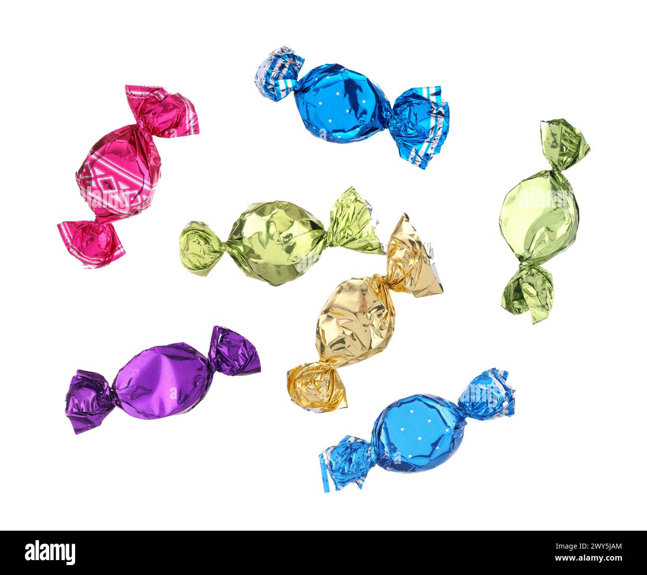 Candies in bright wrappers falling on white background Stock Photo
