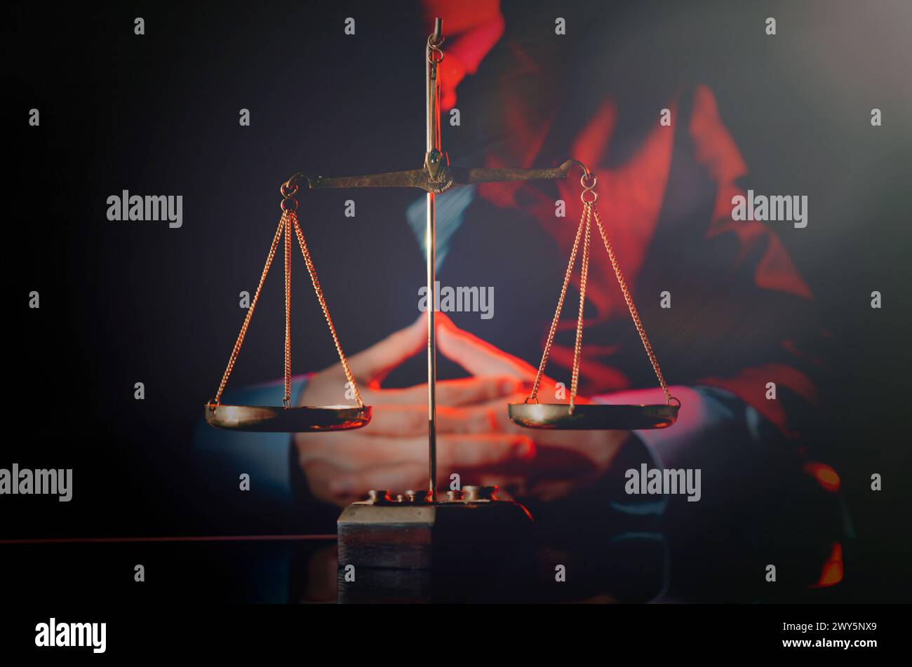 A man is standing in front of a scale with a tie. Concept of professionalism and seriousness, as the man is dressed in a suit and tie, and the scale i Stock Photo