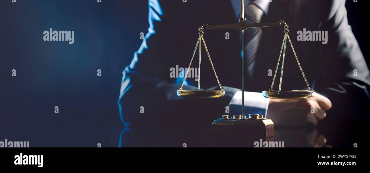 A man is standing in front of a scale with a tie. Concept of professionalism and seriousness, as the man is dressed in a suit and tie, and the scale i Stock Photo