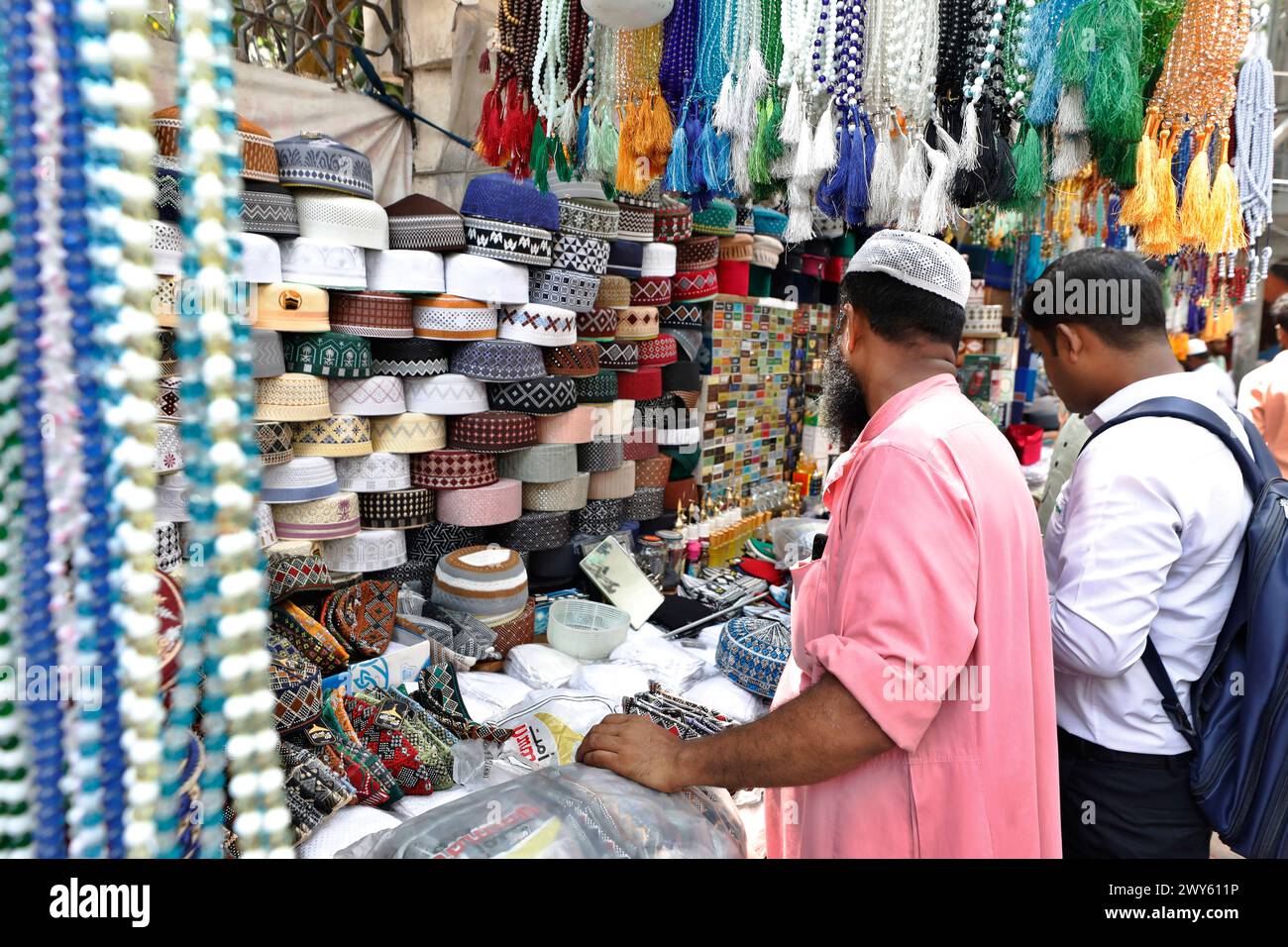 Dhaka, Bangladesh - April 04, 2024: On the occasion of the holy Eid, many worshipers are buying Attar, caps and Zaynamaz from the north gate of Baitul Stock Photo