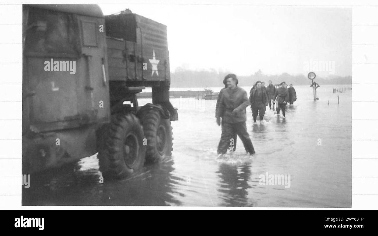 THE MAAS IN FLOOD NEAR MAESEYK - Sappers of the Royal Engineers wade through the floods on the river banks, as they make their way to dinner. , British Army, 21st Army Group Stock Photo
