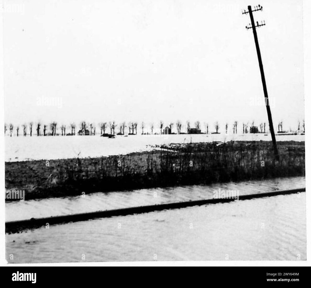 GENERAL SCENES - REICHSWALD AREA - The bridge which can be seen in the distance is resting on a Churchill tank. This and the top of the turrets of two other tanks can just be seen in the waters outside Kranenburg. , British Army, 21st Army Group Stock Photo