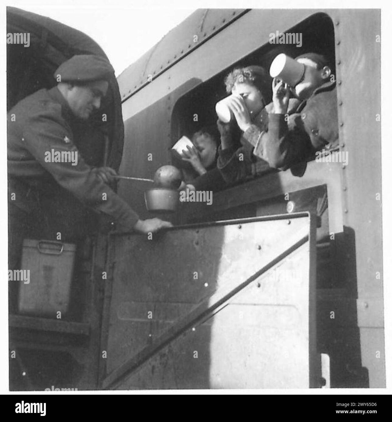 EVACUATION OF DUTCH CHILDREN TO ENGLAND - When the train draws in at a continental port, English soldiers serve soup. , British Army, 21st Army Group Stock Photo