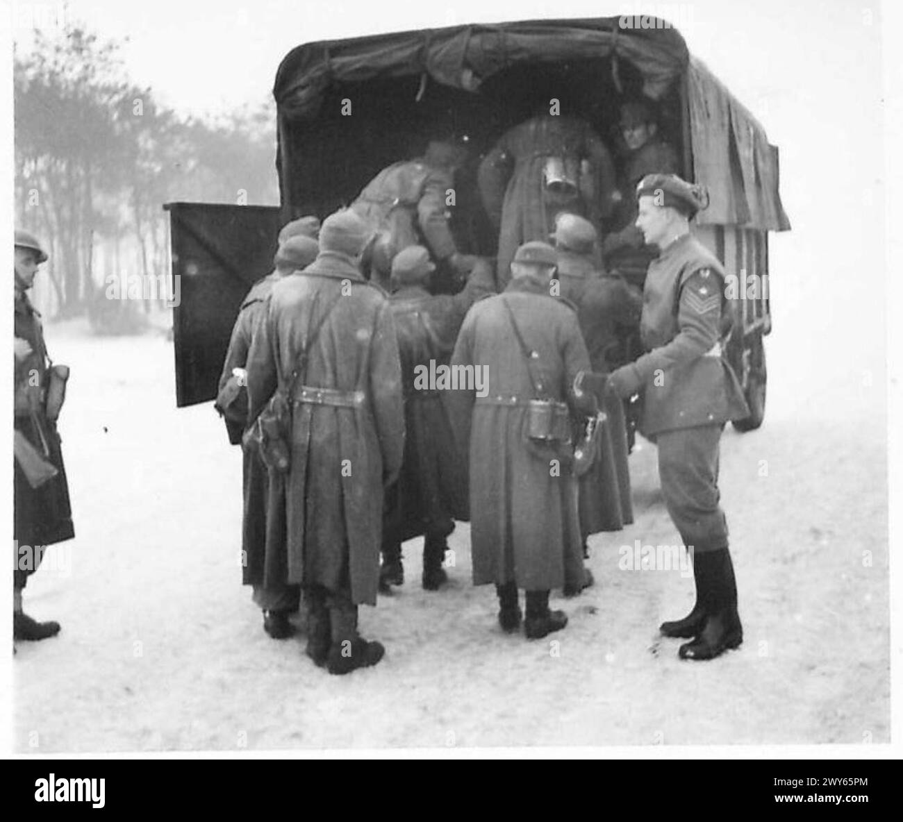 PS. C W - P.O.W. embussing into a T.O.U. which is used for transporting prisoners from one cage to another. , British Army, 21st Army Group Stock Photo