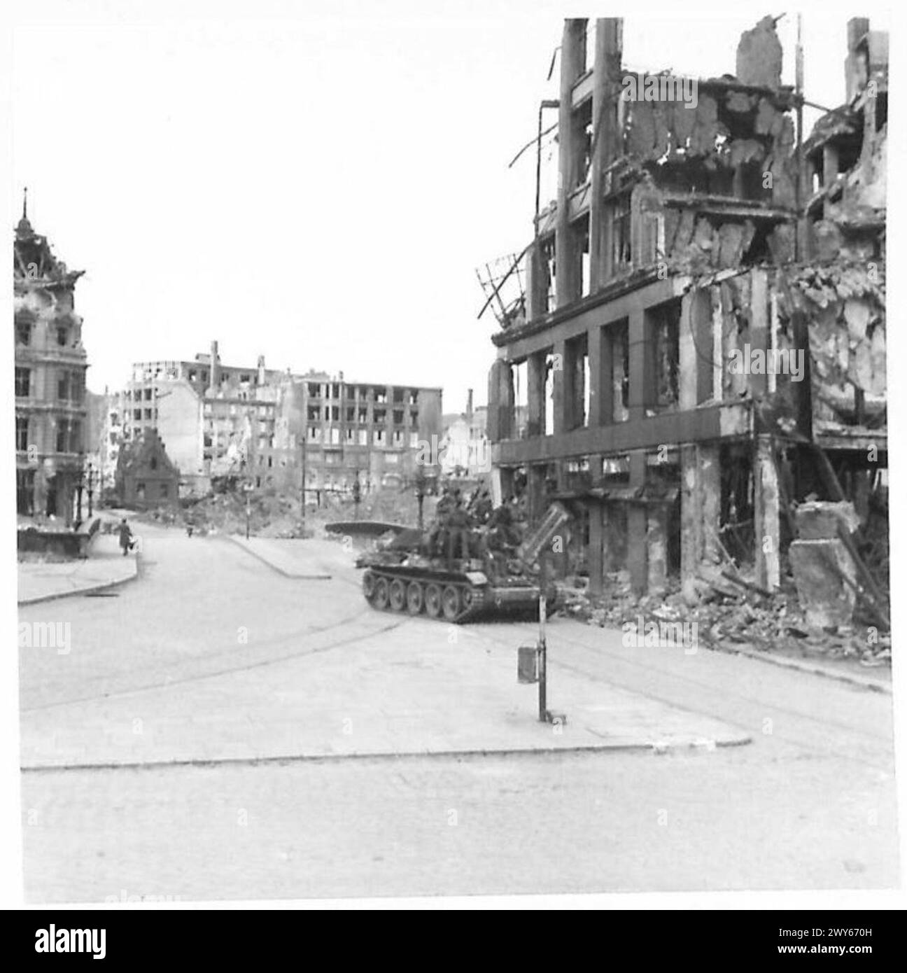 SECOND DAY IN HAMBURG AFTER SURRENDER OF TOWN - A Cromwell tank moves through a street wrecked by R.A.F. bombing in Hamburg. , British Army, 21st Army Group Stock Photo