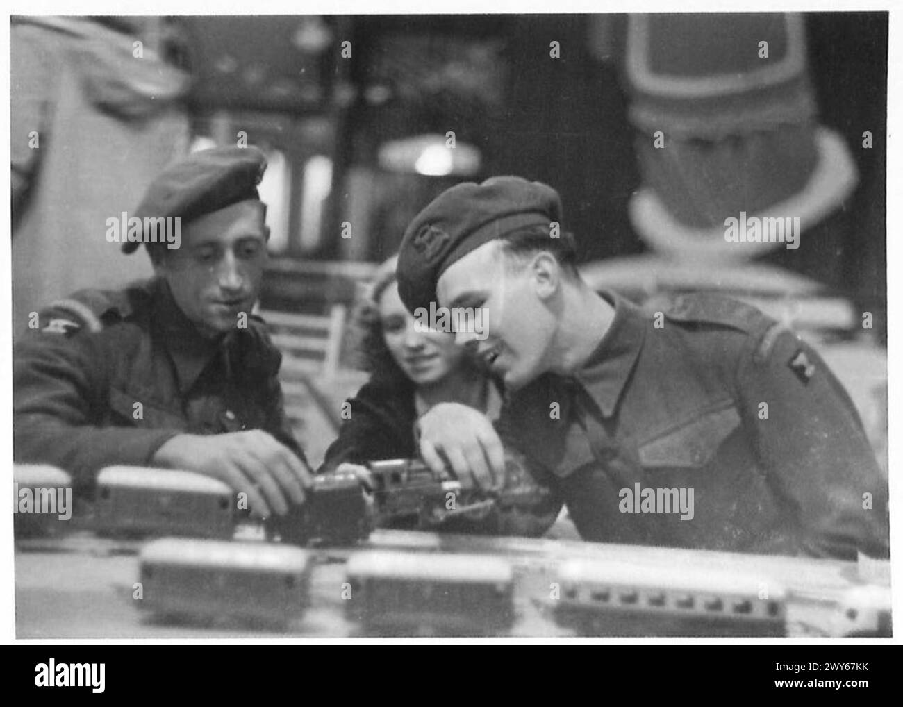 LUXURY LEAVE FOR TROOPS IN BRUSSELS - Troops in a Brussels toy shop play with toy trains, probably made in Germany. , British Army, 21st Army Group Stock Photo